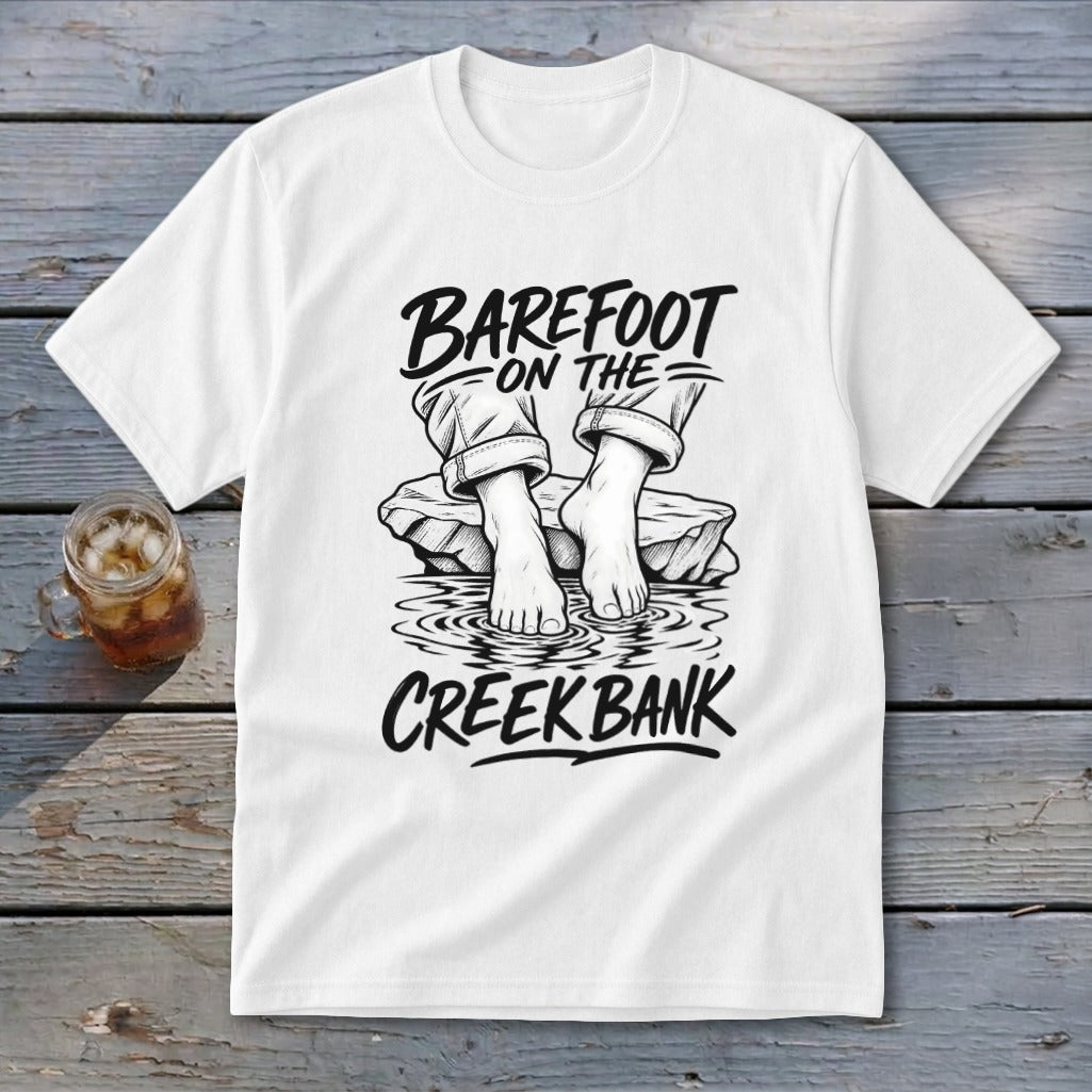 White t-shirt with "Barefoot on the Creek Bank" text and graphic.