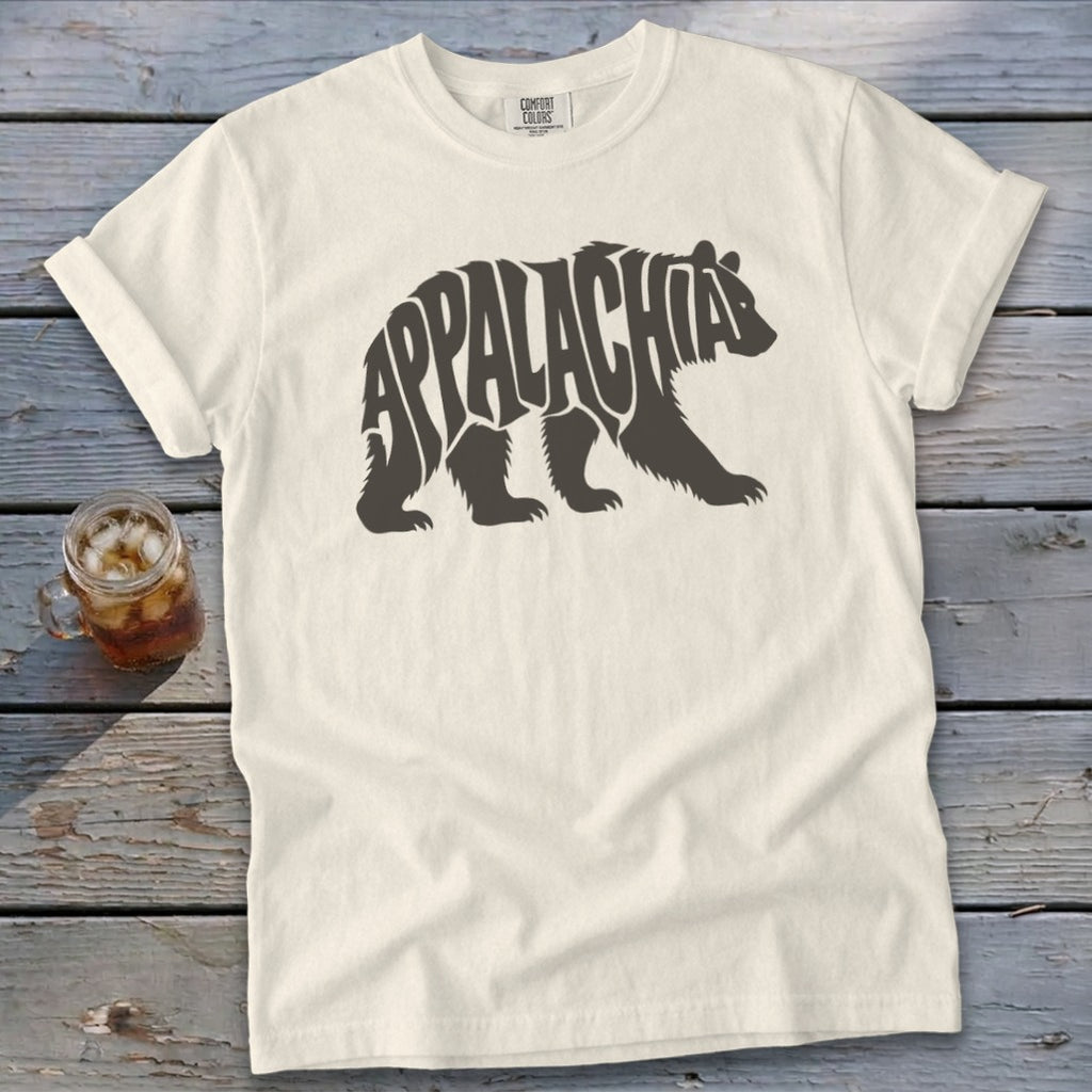 A cream-colored t-shirt with a dark brown graphic of a bear containing the word Appalachia.