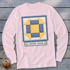 Pink long-sleeved shirt with a Churn Dash quilt block design.