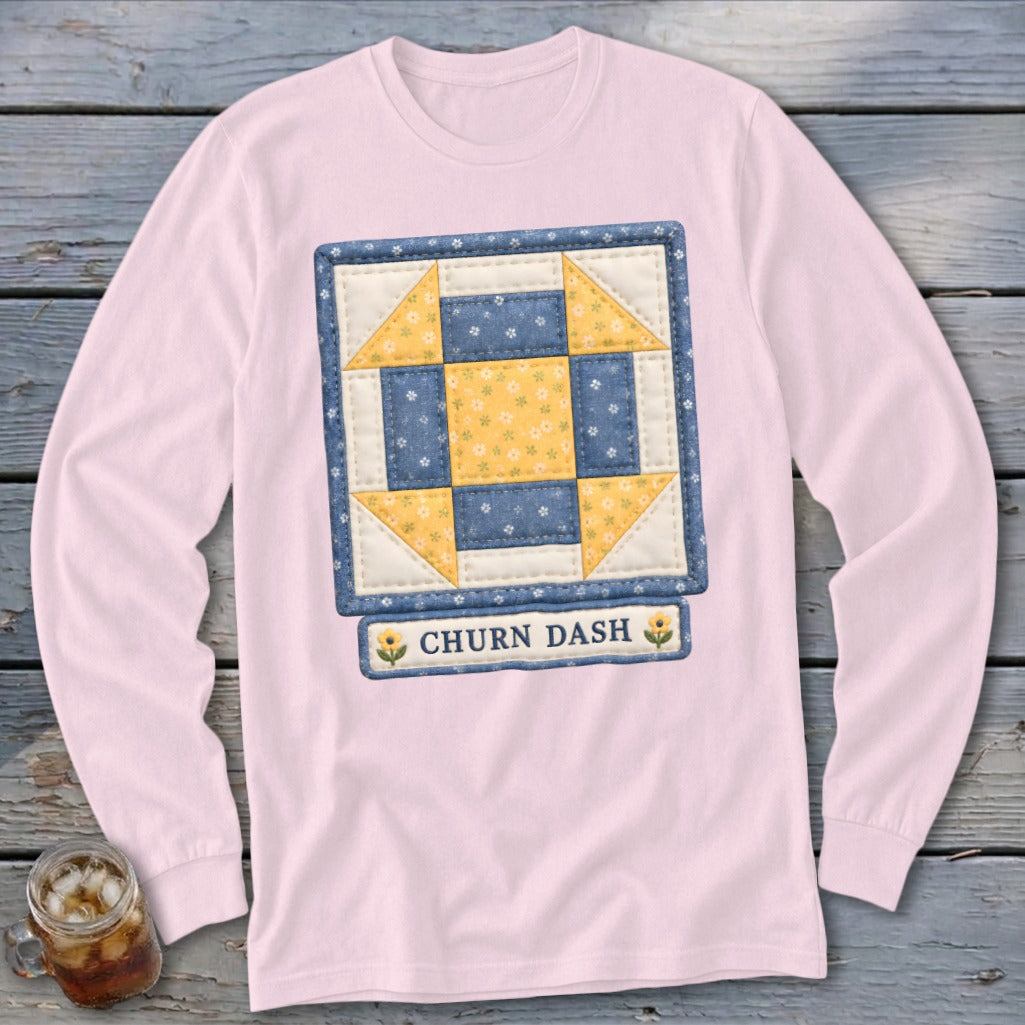 Pink long-sleeved shirt with a Churn Dash quilt block design.