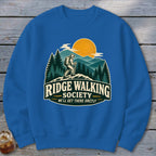 Blue sweatshirt with "Ridge Walking Society" graphic featuring a hiker and mountains.