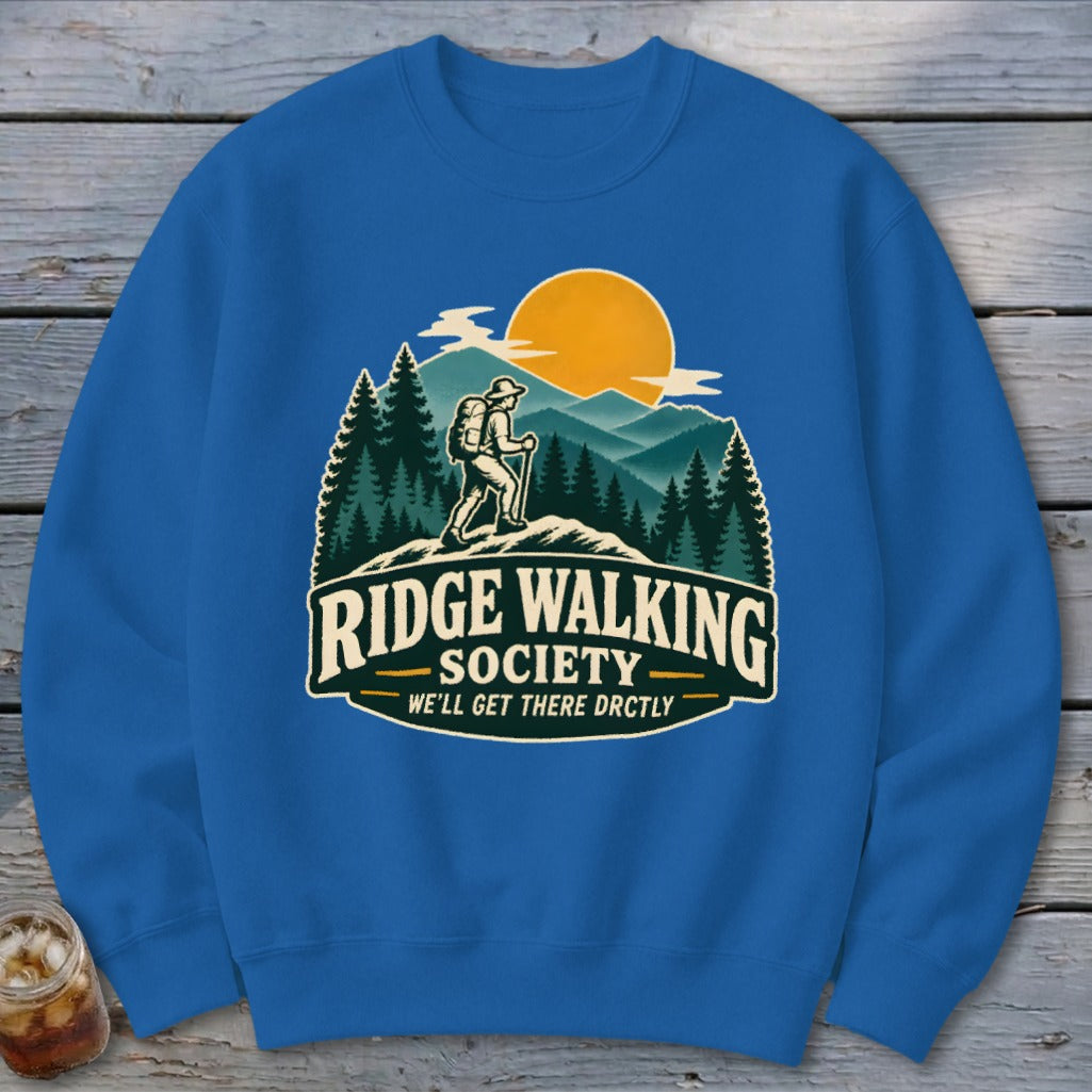Blue sweatshirt with "Ridge Walking Society" graphic featuring a hiker and mountains.