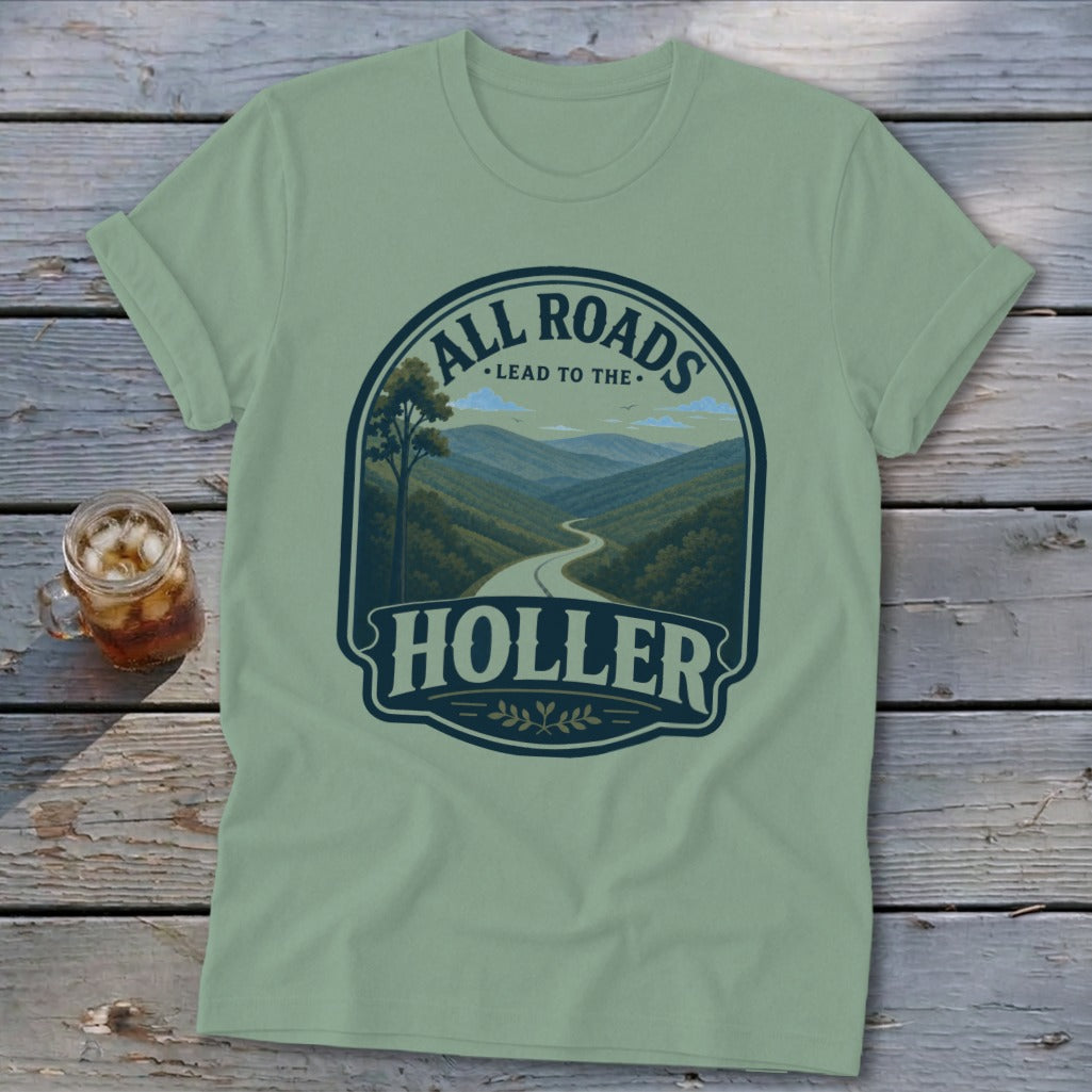 Light green t-shirt with a graphic of a winding mountain road and the text "ALL ROADS LEAD TO THE HOLLER".