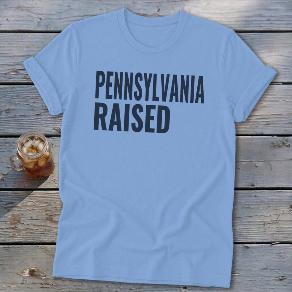 Light blue t-shirt with black text reading "PENNSYLVANIA RAISED"