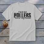 White t-shirt with black text that reads "THESE HOLLERS know my name".