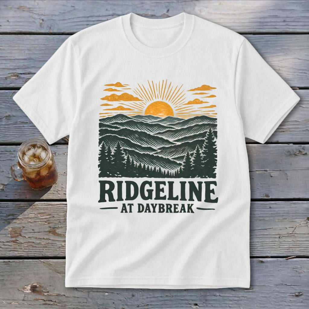 White t-shirt with "RIDGELINE AT DAYBREAK" text and mountain sunrise graphic.