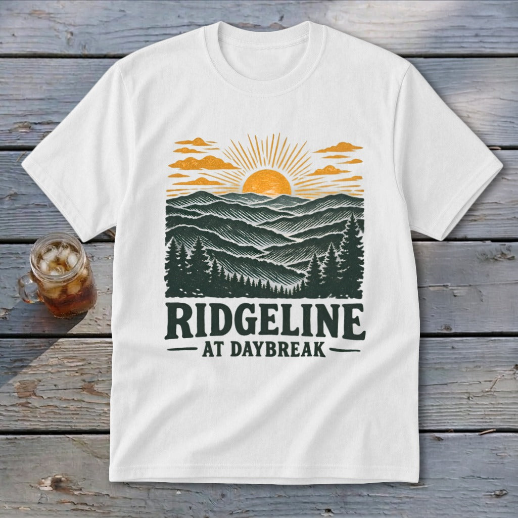 White t-shirt with "RIDGELINE AT DAYBREAK" text and mountain sunrise graphic.