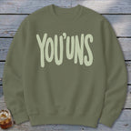 Olive green crewneck sweatshirt with "YOU'UNS" in light green distressed font.