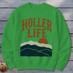 Green crewneck sweatshirt featuring a distressed orange mountain sunset graphic and the text HOLLER LIFE.