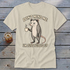 Opossum holding coffee mug with text "Don't mind me, I'm just sulled up."
