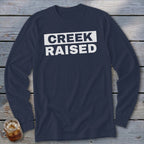Navy long sleeve shirt with white text reading "CREEK RAISED".