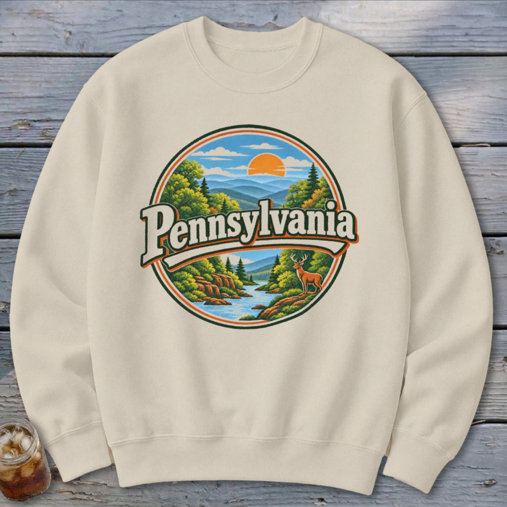 Cream sweatshirt with vintage Pennsylvania landscape and deer graphic.