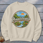 Cream sweatshirt with vintage Pennsylvania landscape and deer graphic.