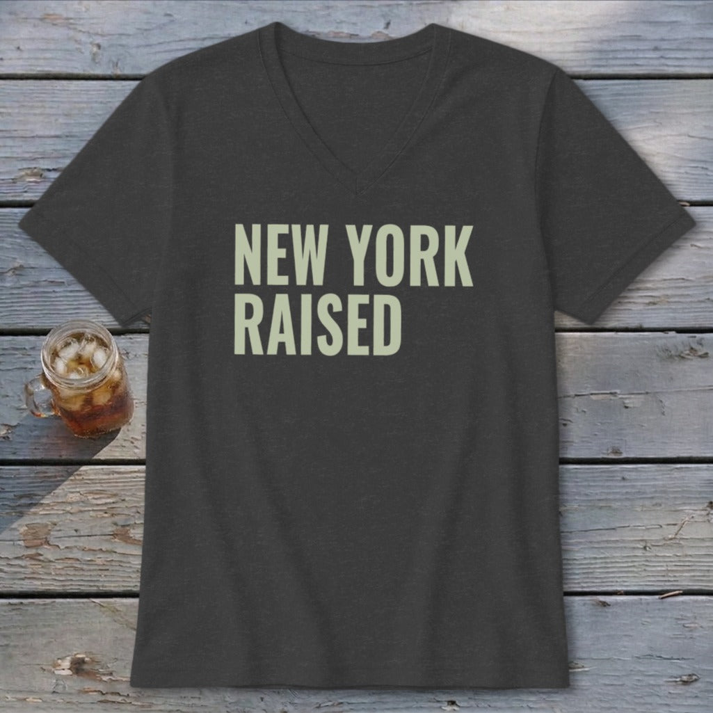 Dark grey v-neck t-shirt with "NEW YORK RAISED" text in light green.