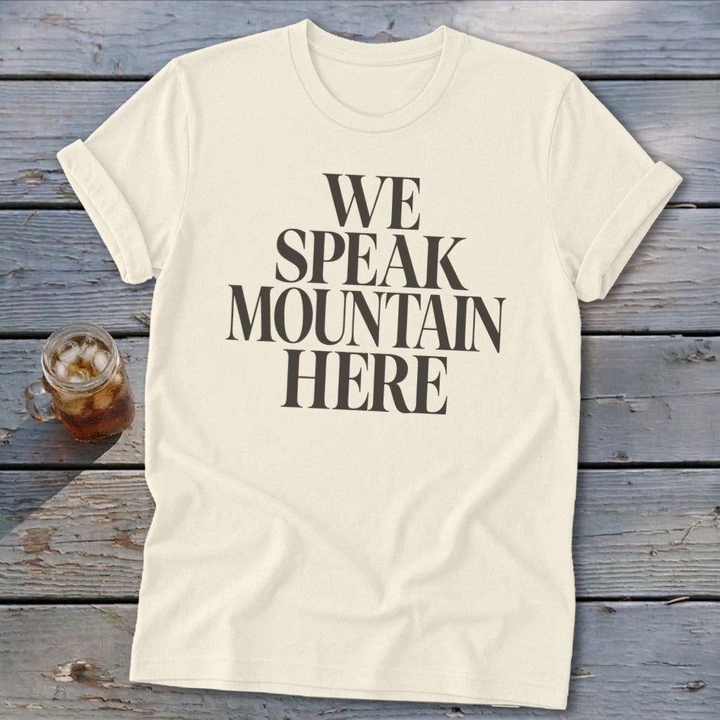 Cream t-shirt with black text that reads "WE SPEAK MOUNTAIN HERE".
