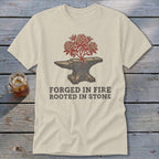 Anvil with blooming tree and text "FORGED IN FIRE ROOTED IN STONE".