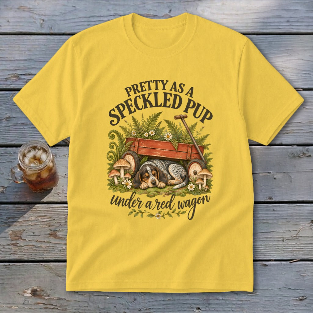 Yellow t-shirt with speckled pup graphic under a red wagon.