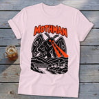 Pink t-shirt with black and orange Mothman design featuring glowing eyes and a town.