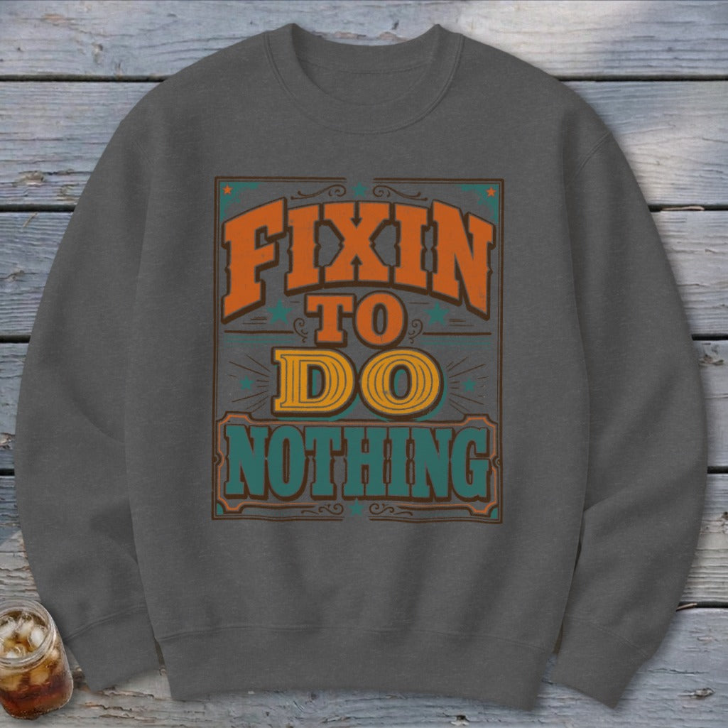Crewneck sweatshirt with orange and green text reading "FIXIN TO DO NOTHING".