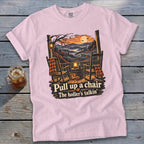 Pink t-shirt with porch scene and text "Pull up a chair The holler's talkin'".