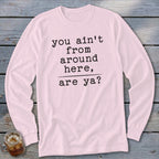 Pink long-sleeve shirt with black text "you ain't from around here, are ya?"