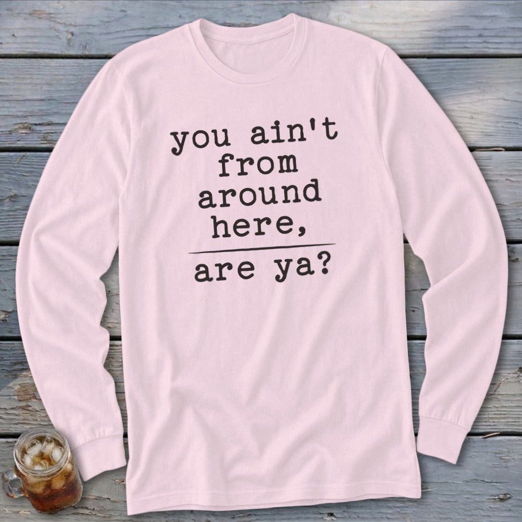 Pink long-sleeve shirt with black text "you ain't from around here, are ya?"