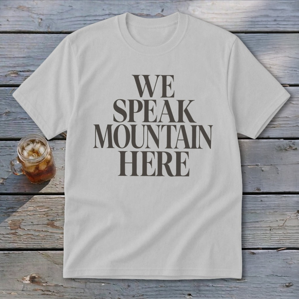 Light grey t-shirt with dark grey text reading "WE SPEAK MOUNTAIN HERE."