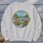 White sweatshirt featuring a circular graphic of a Tennessee landscape with a deer.