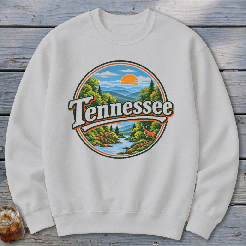 White sweatshirt featuring a circular graphic of a Tennessee landscape with a deer.