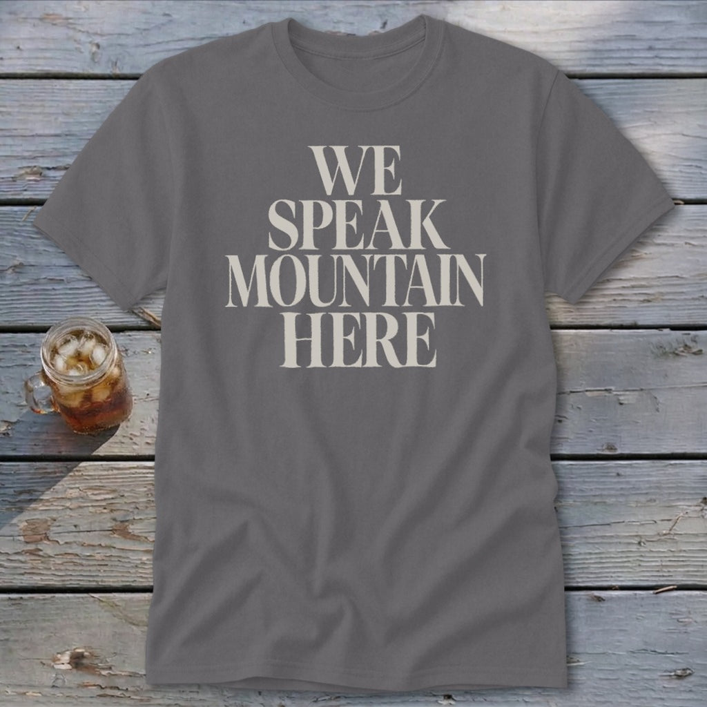 Grey t-shirt with "We Speak Mountain Here" text in cream font.