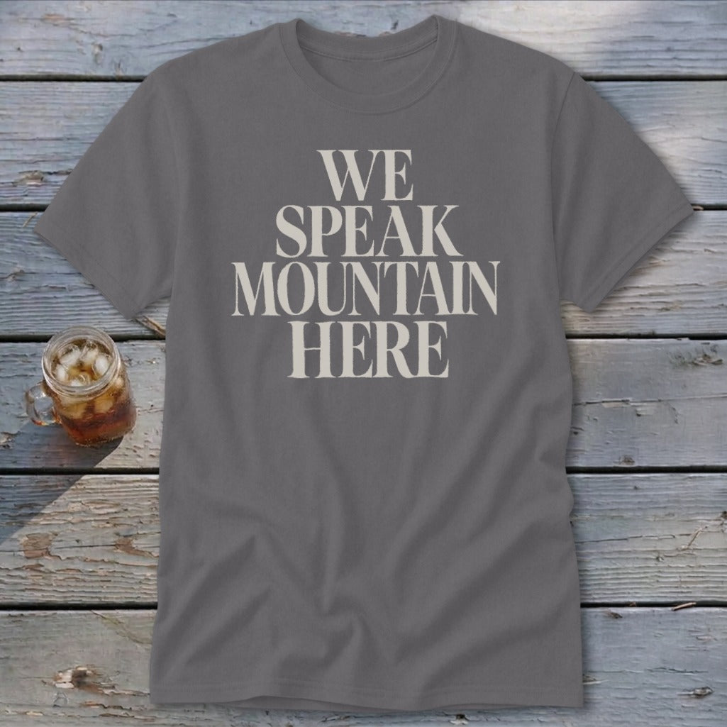 Grey t-shirt with "We Speak Mountain Here" text in cream font.