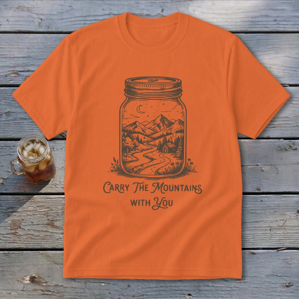 Orange crewneck t-shirt featuring a mason jar graphic containing a mountain scene with text reading Carry The Mountains With You.