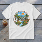 White t-shirt with a circular Georgia graphic featuring mountains, a river, deer, and trees.