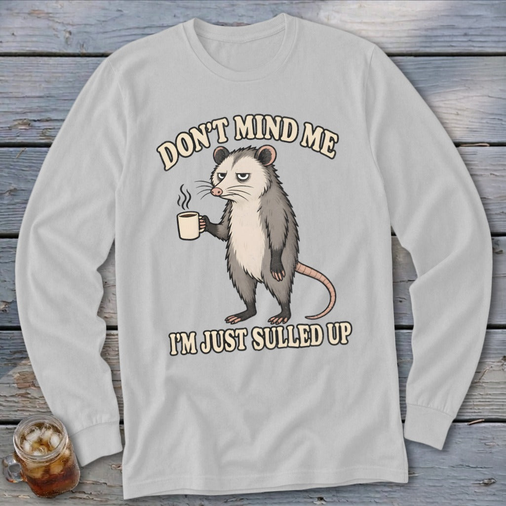 Long sleeve shirt with cartoon possum holding coffee, text "DON'T MIND ME I'M JUST SULLED UP".