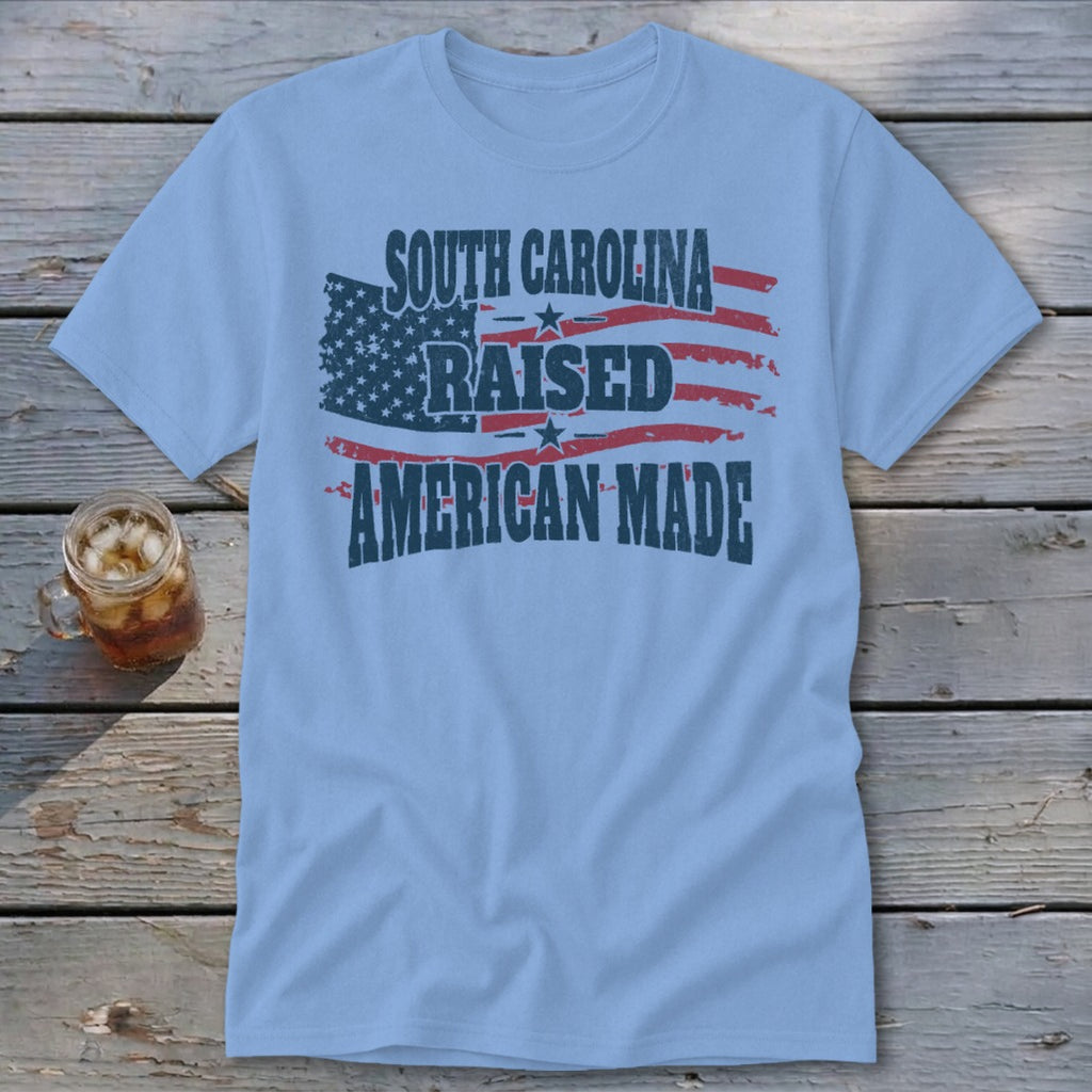 Light blue t-shirt with distressed American flag graphic and text.