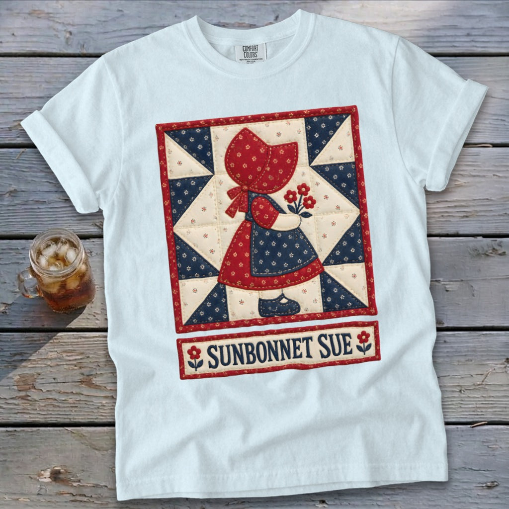 White t-shirt with a "Sunbonnet Sue" quilt design featuring a girl holding flowers.