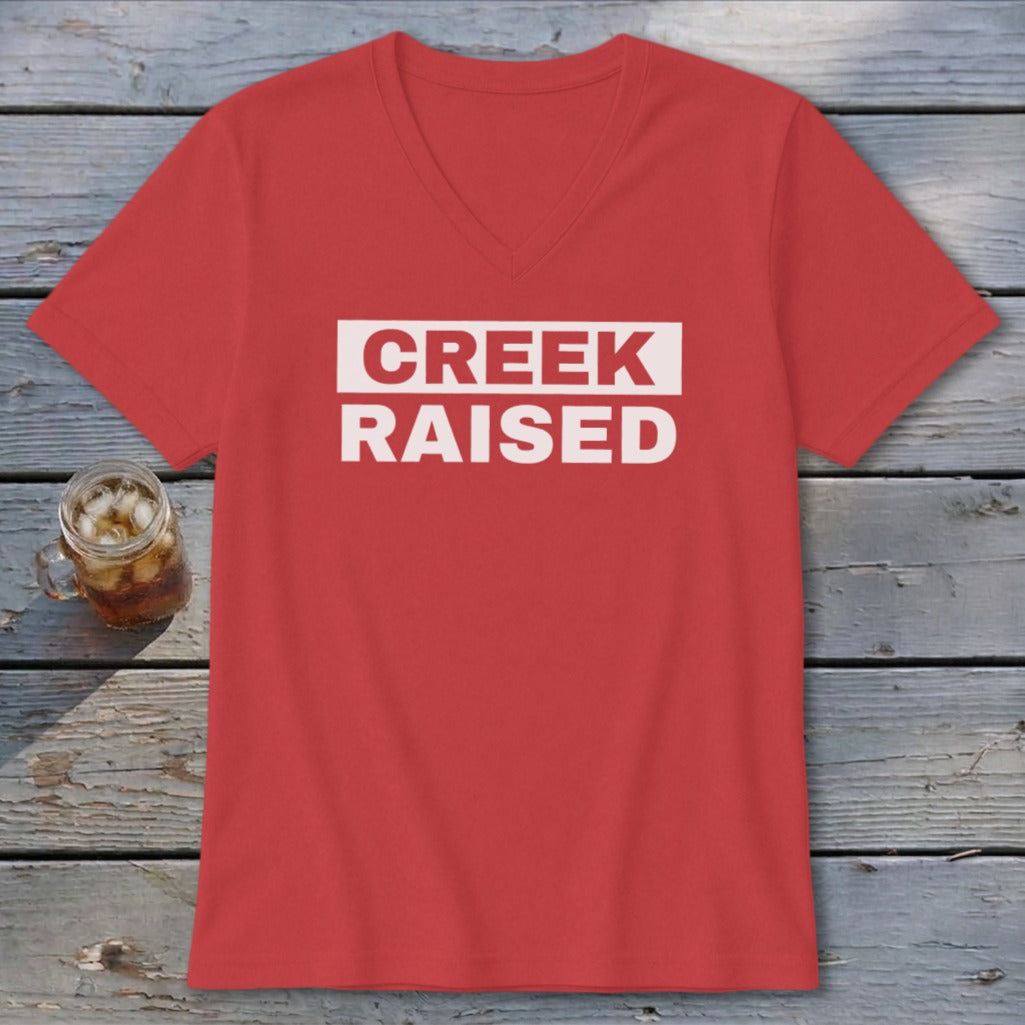 Red v-neck t-shirt with "CREEK RAISED" text in white box.