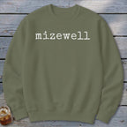 Olive green crewneck sweatshirt with white "mizewell" text on the chest.