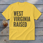 Yellow t-shirt with "West Virginia Raised" text in dark gray.