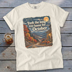 Cream t-shirt with vintage-style graphic: "Took the long way home for October."