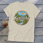 Cream t-shirt with circular Kentucky landscape graphic featuring deer and river.