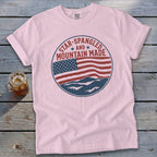 Pink t-shirt with a circular graphic featuring a distressed American flag and mountains.
