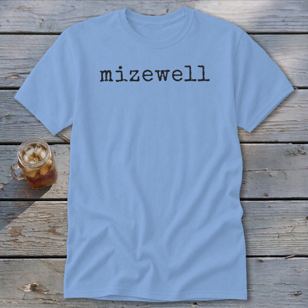 Light blue t-shirt with "mizewell" text in black, next to a mason jar drink.