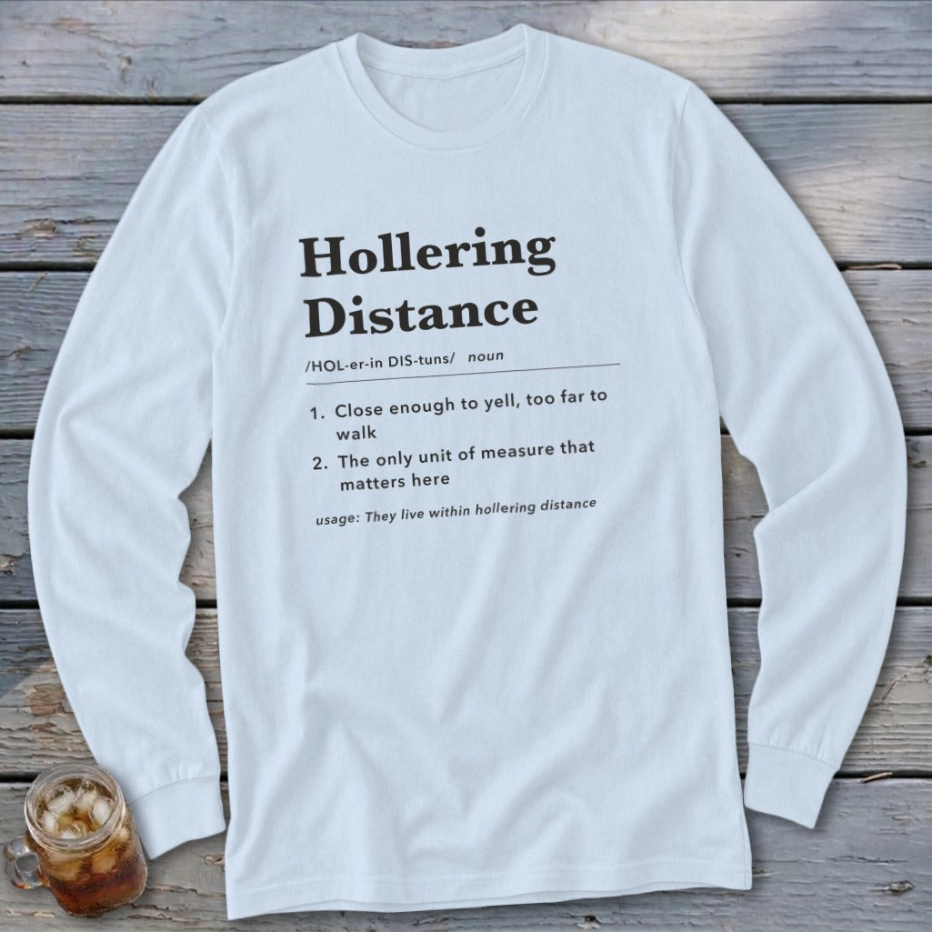 White long-sleeve shirt with "Hollering Distance" definition printed on it.