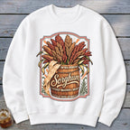 White sweatshirt featuring a graphic of sorghum stalks in a wooden barrel with the word "Sorghum".