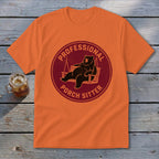 An orange t-shirt featuring a circular graphic of a bear lounging on a porch swing, with the text PROFESSIONAL PORCH SITTER.