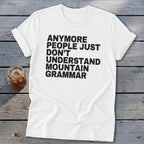 White t-shirt with black text reading "Anymore people just don't understand mountain grammar."