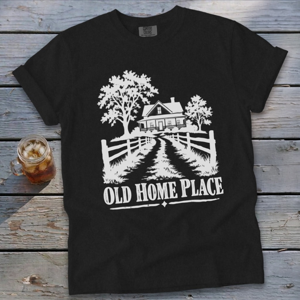 Black t-shirt with white graphic of a farmhouse, trees, and text "OLD HOME PLACE".
