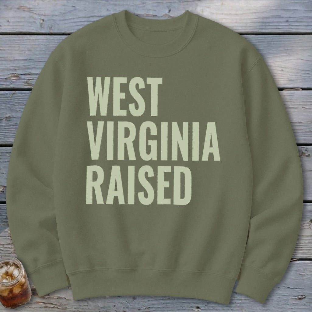 Olive green sweatshirt with "WEST VIRGINIA RAISED" text in light beige.
