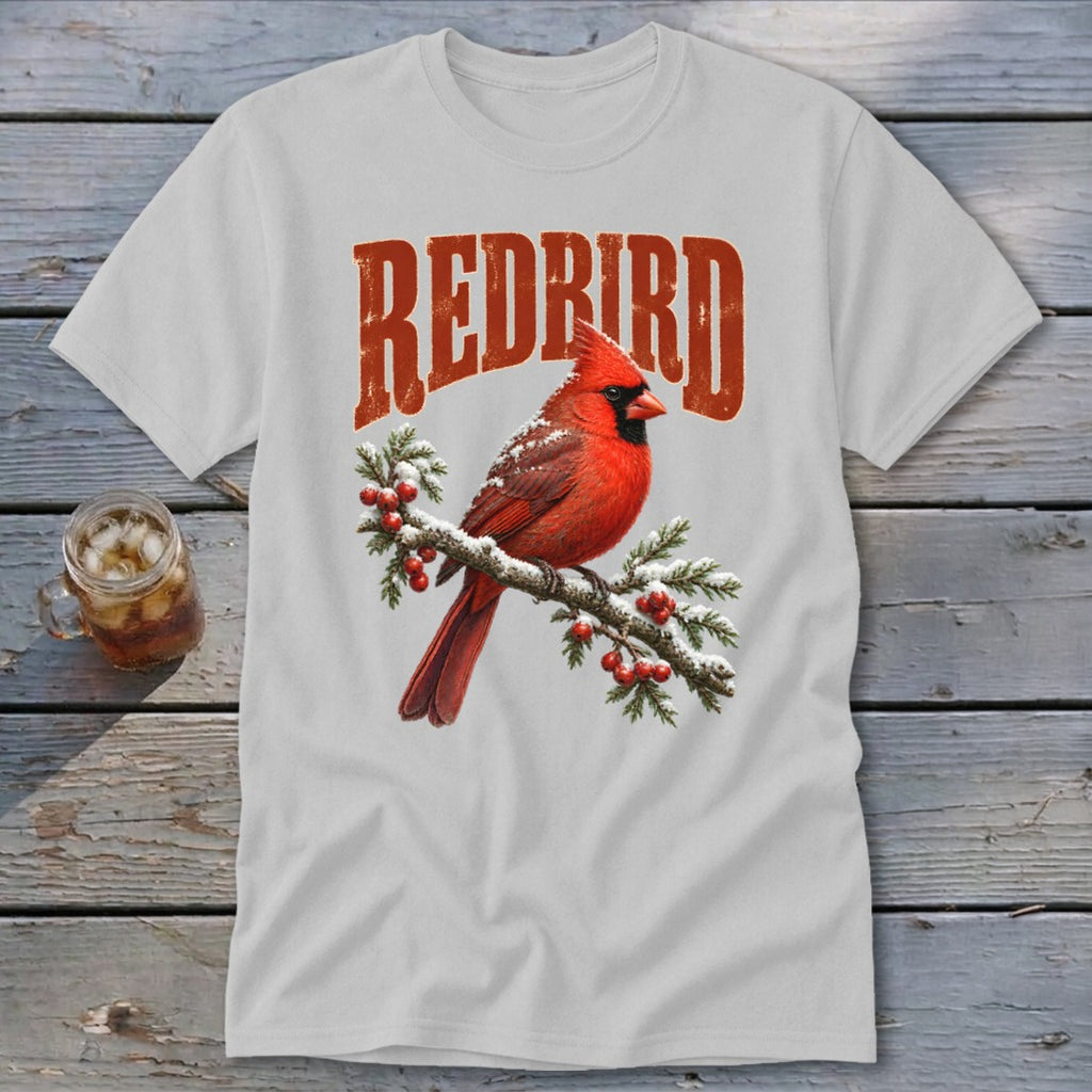 A light gray t-shirt featuring a graphic of a red cardinal on a snowy branch with the text "REDBIRD".